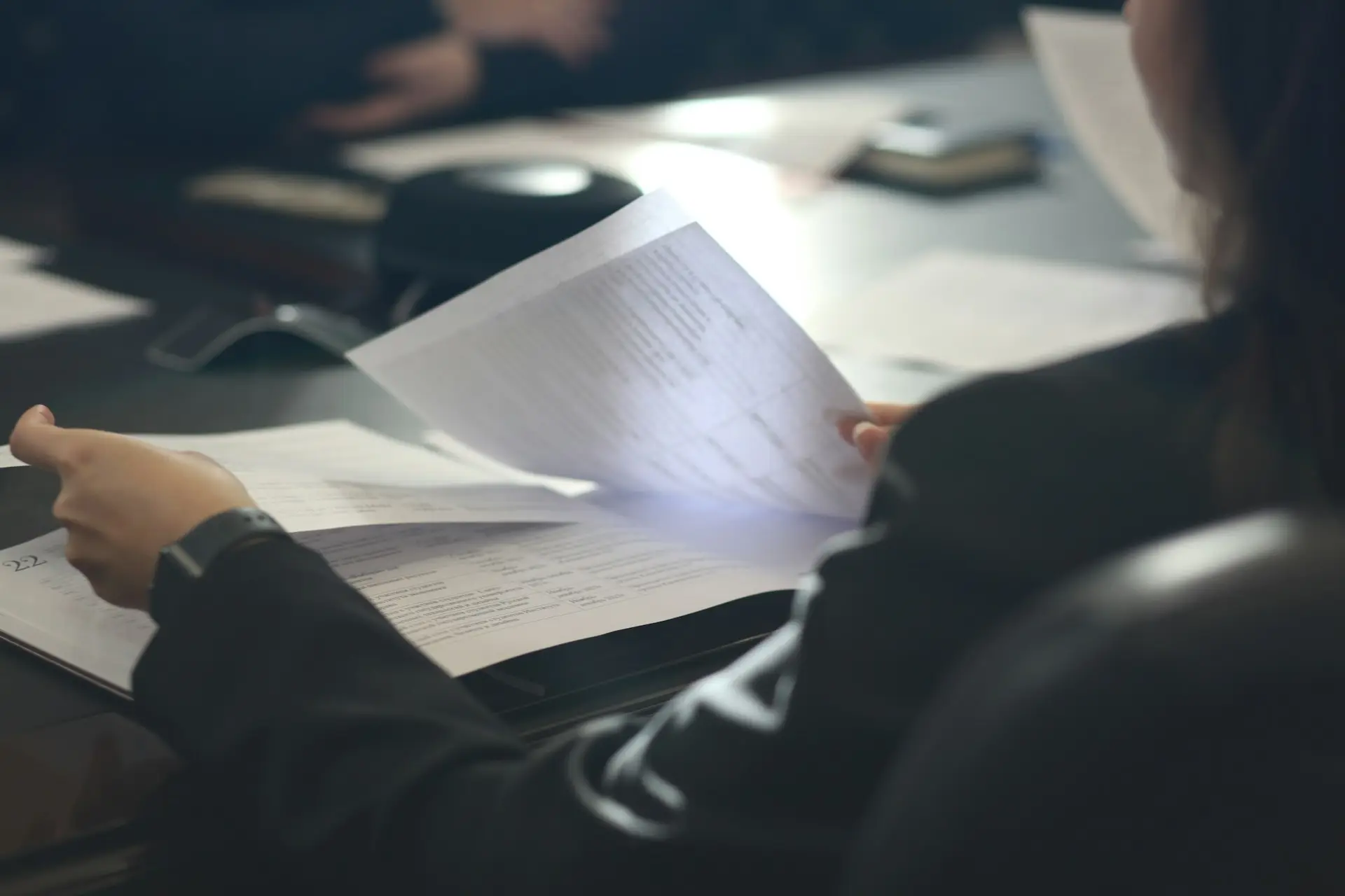 Audit review with magnifying glass over documents